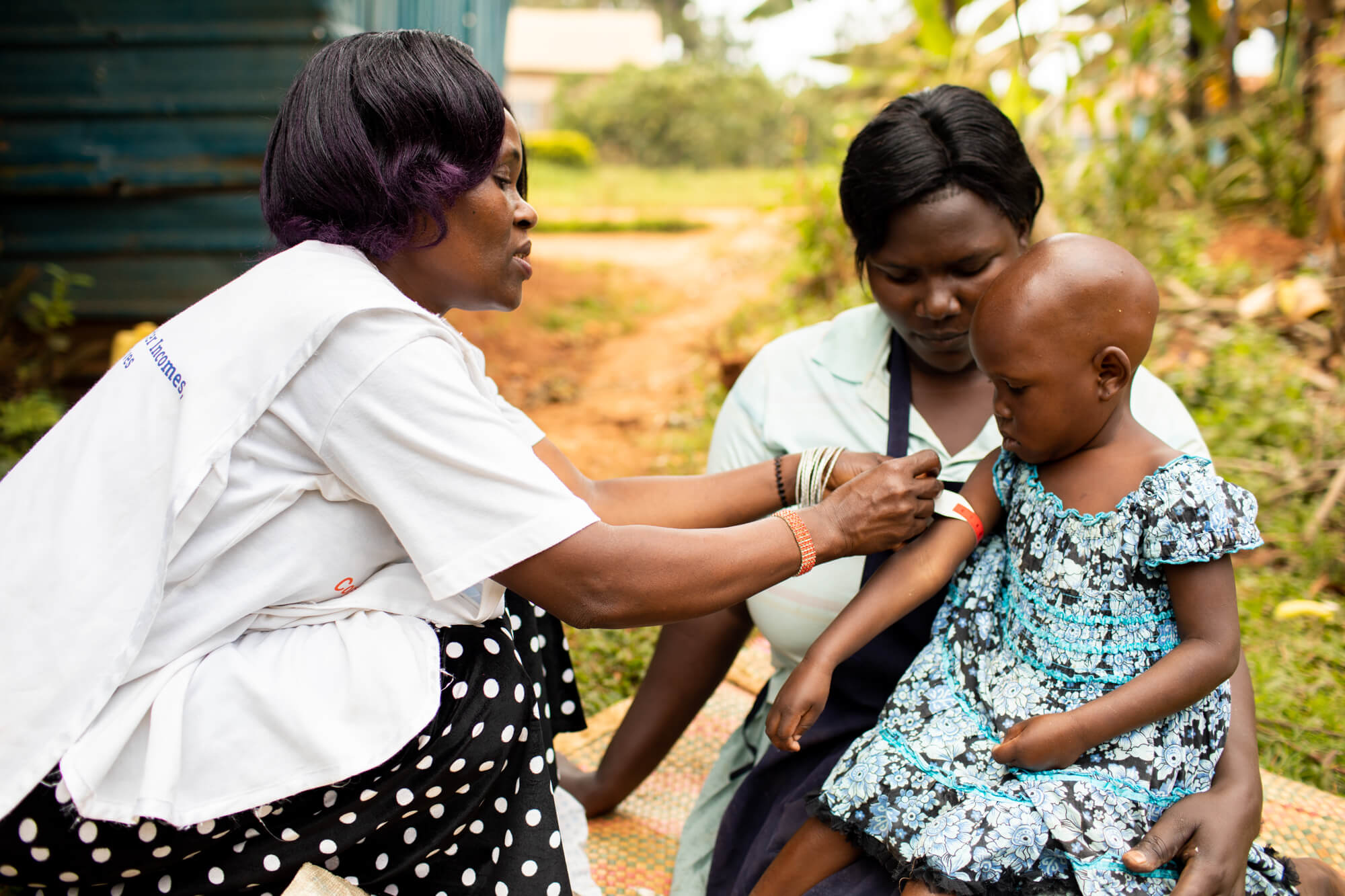 Christine checking child for malnutrition