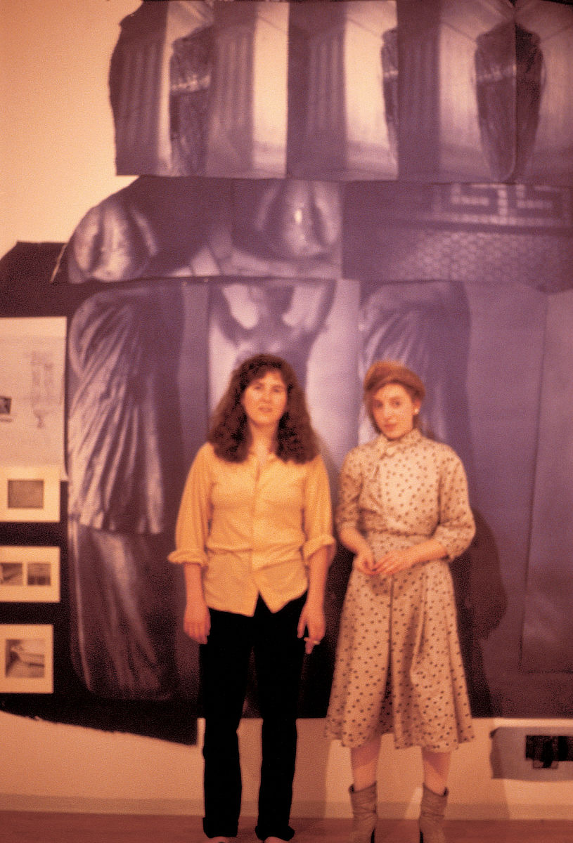 Francesca standing in front of her artwork