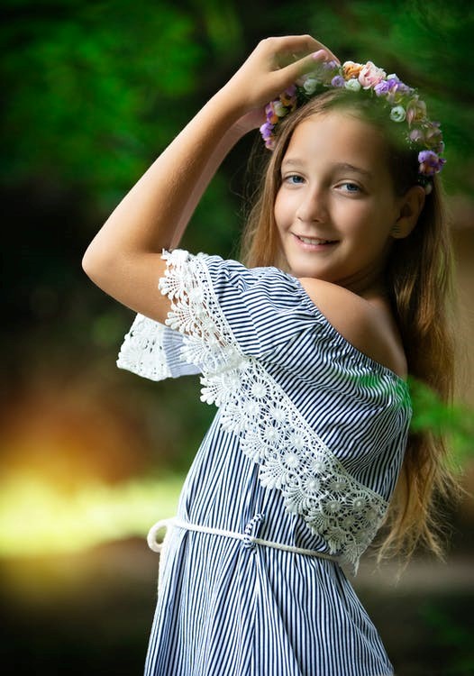 Girl Clad in A Cotton Dress with Borders Made of a Laser Cut Garment Pattern