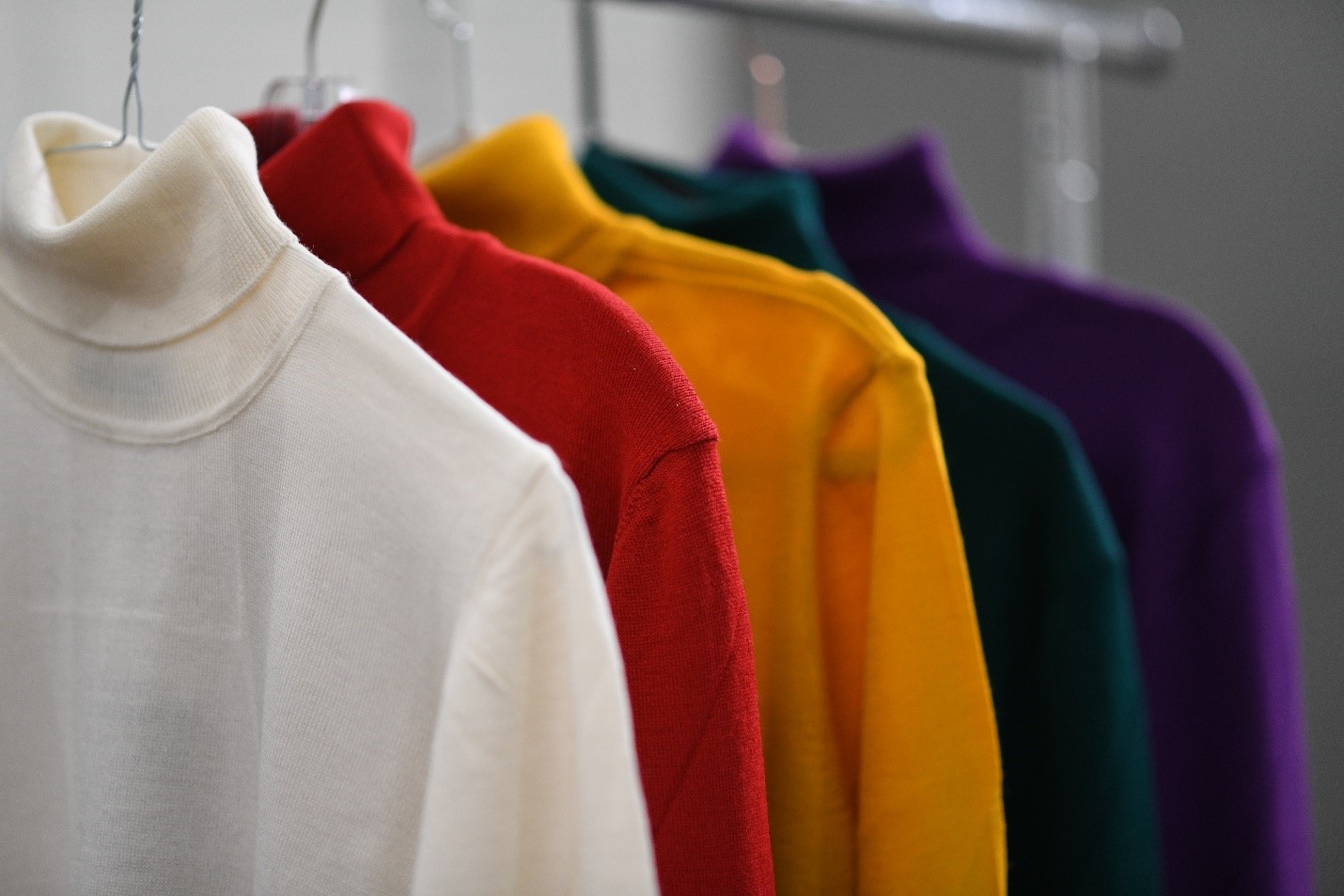 Assorted turtleneck apparel hanging in a clothing company