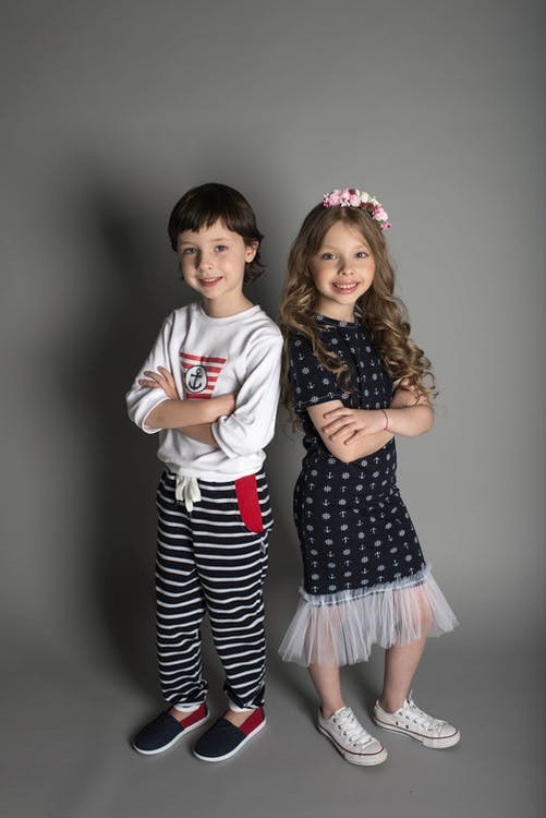 a girl and a boy wearing fashionable clothes