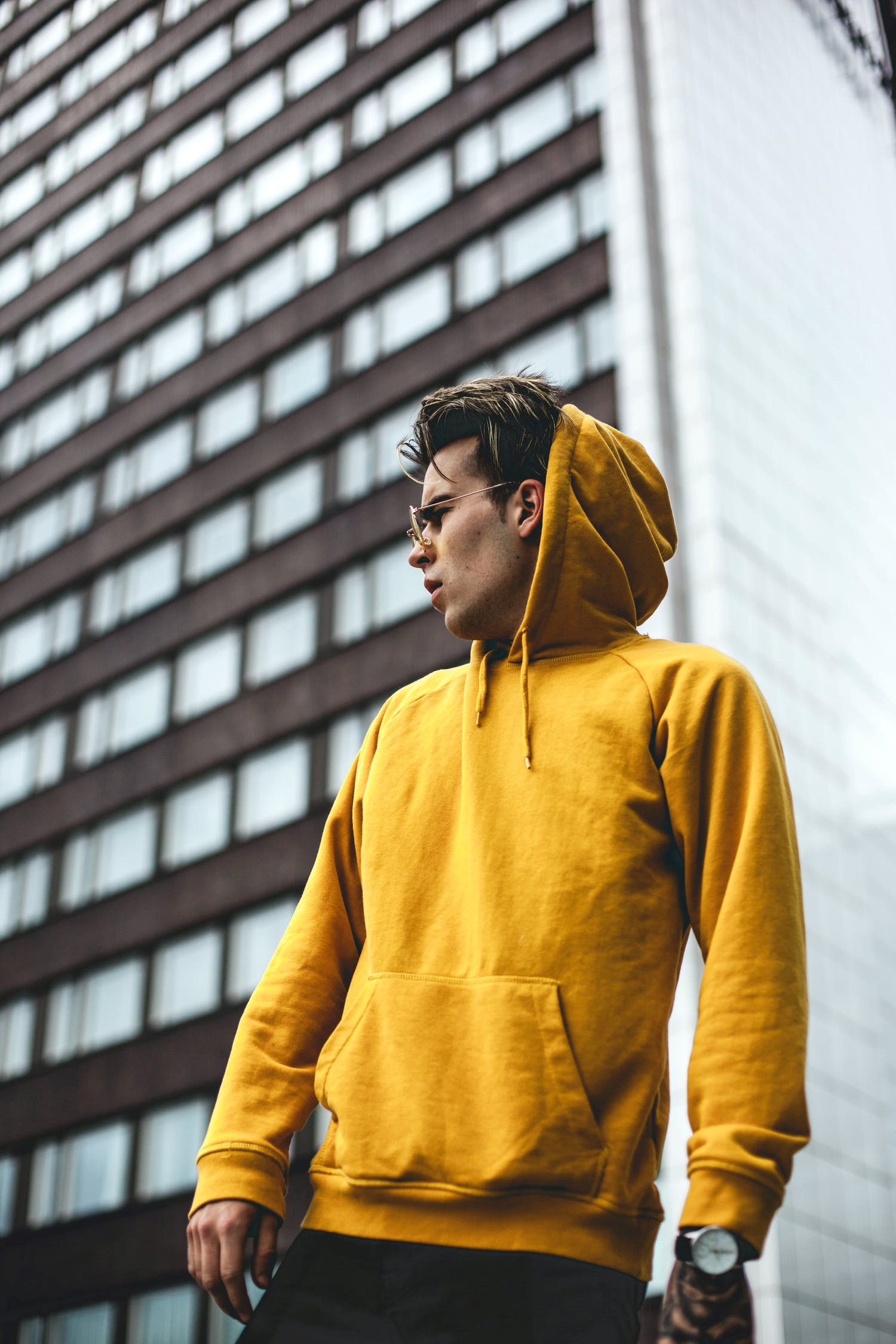 A man wearing a hoodie made by a men’s garments manufacturer in Los Angeles