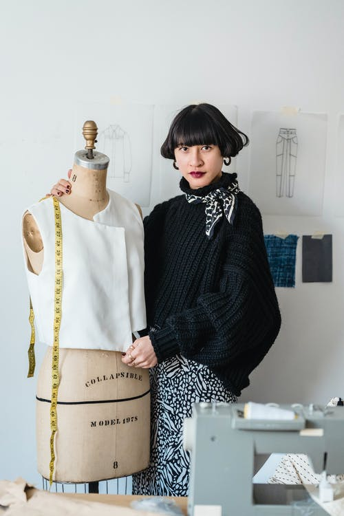 a fashion designer with a mannequin