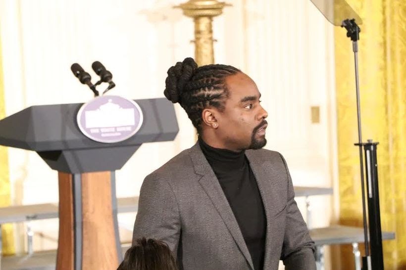 While waiting for Michelle Obama to bid her farewell remarks, Music Artist Wale was spotted standing in the front row of the