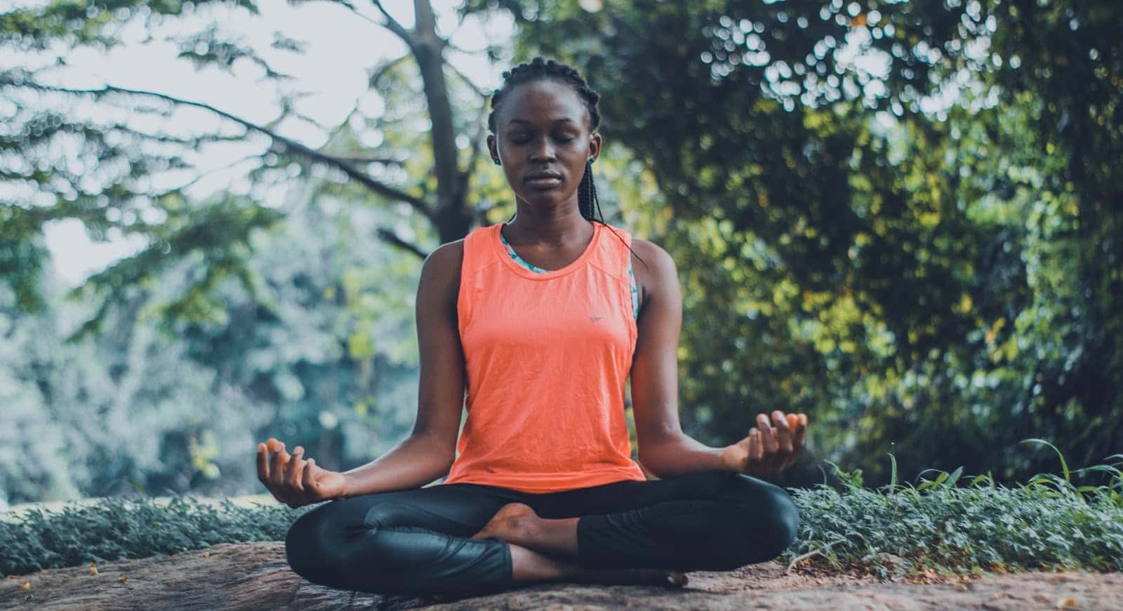 woman meditating in a park