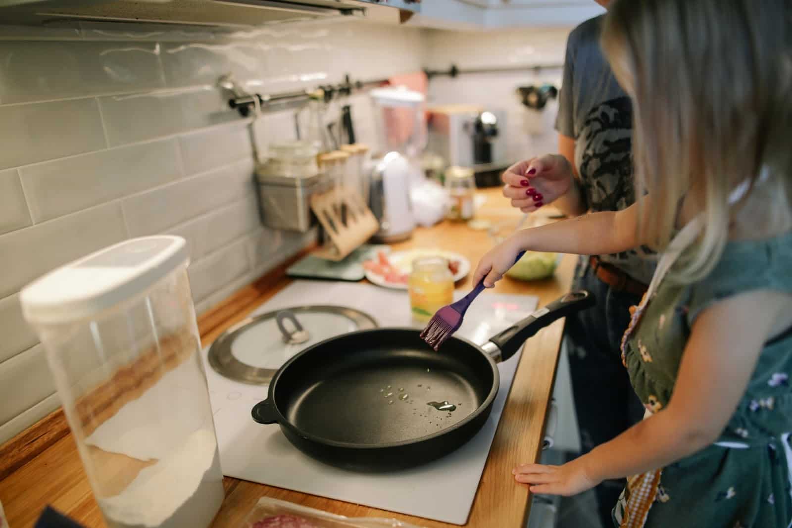 two women cooking in a kitchen