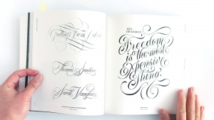 Hand-lettering detail: thick brush strokes forming stylized Arabic letters.