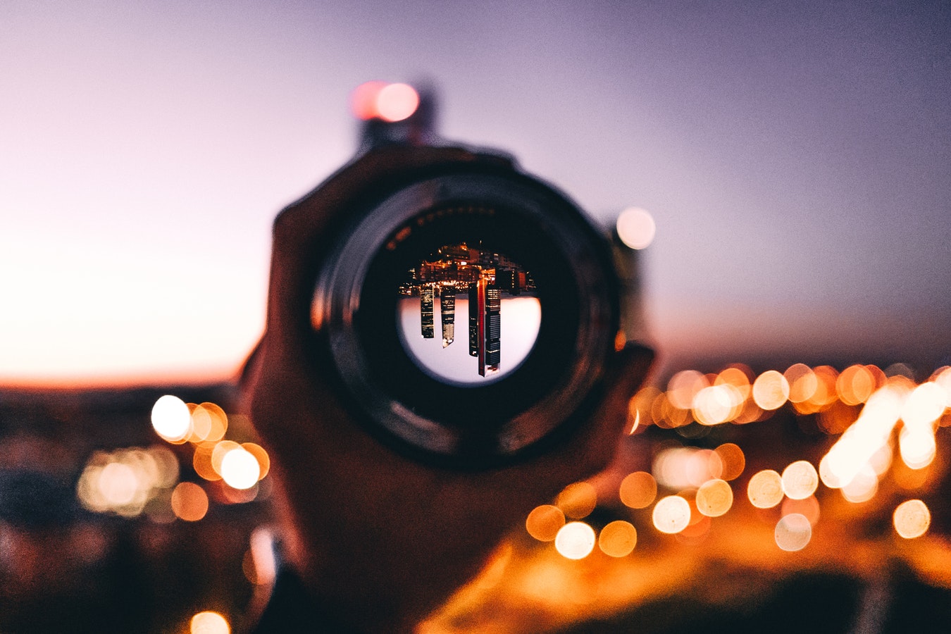 Icon of a camera lens, symbolizing a new perspective or framing.