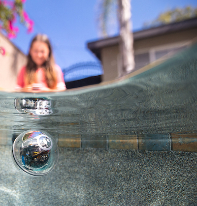 Sphero in the water with a child in the background