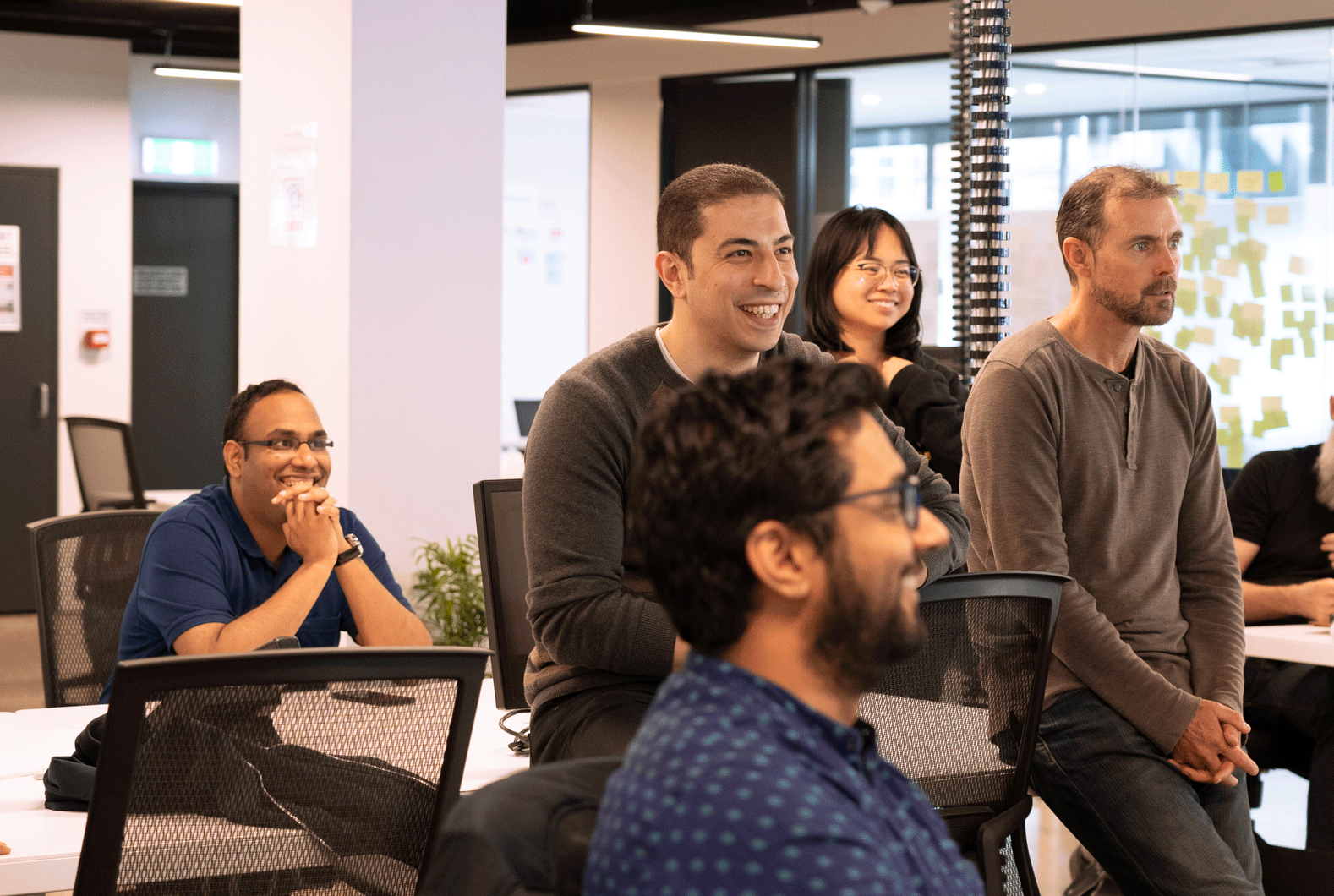 Happy office staff, staff laughing, technology co-workers