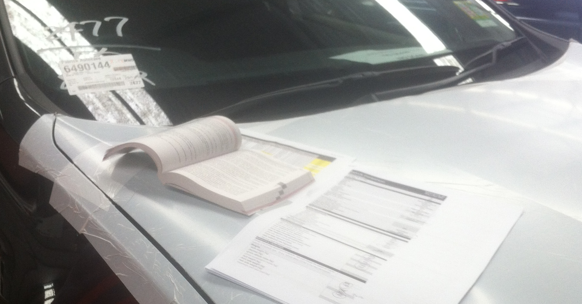 Old paper-check with printed lists over vehicle