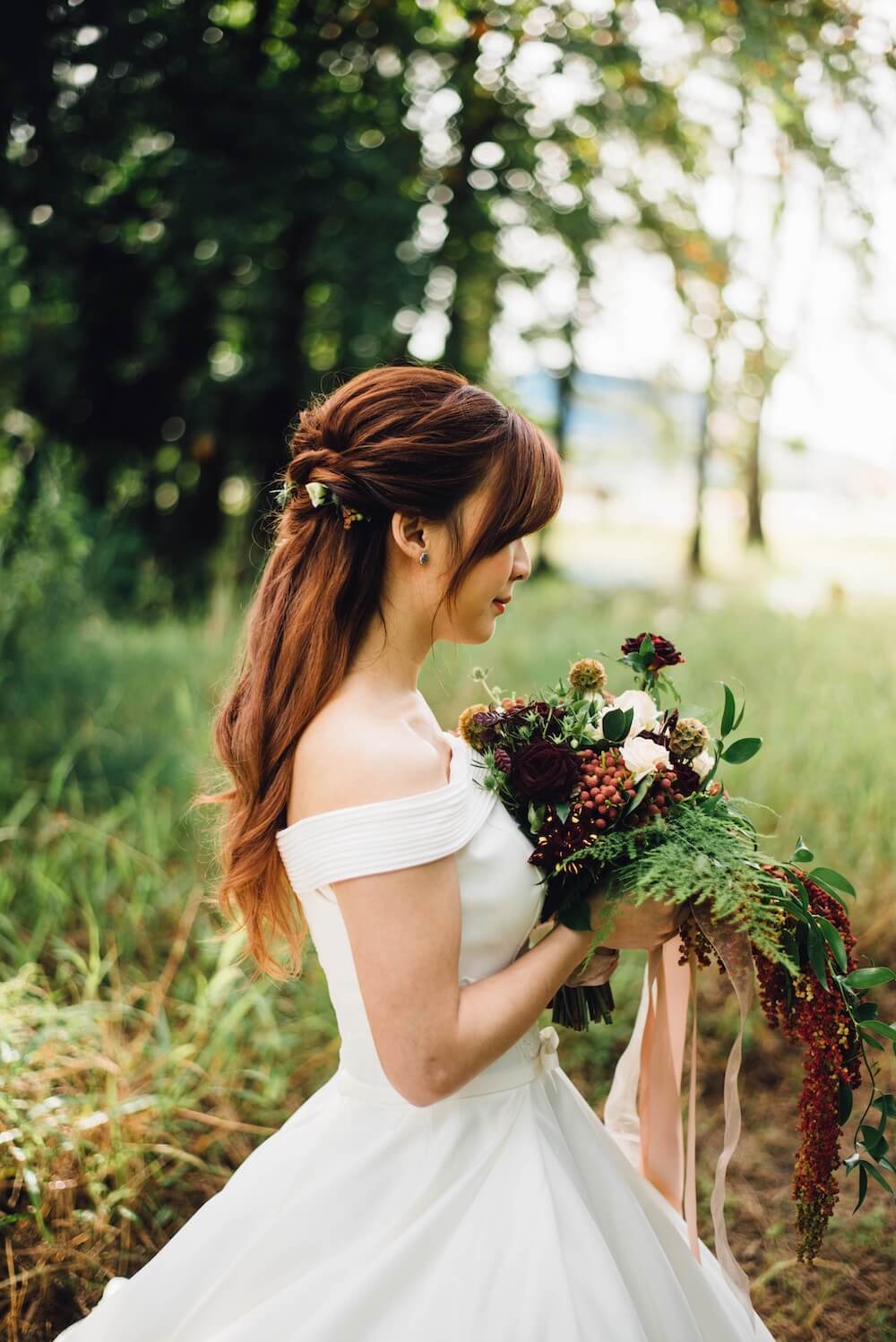 Woman holding large wedding bouquet