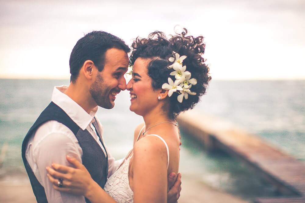 Woman and man touching noses smilling