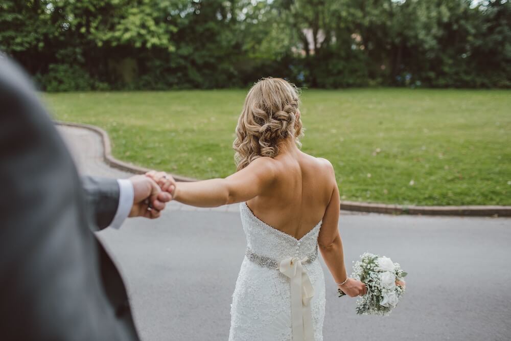 Man holding woman's hand