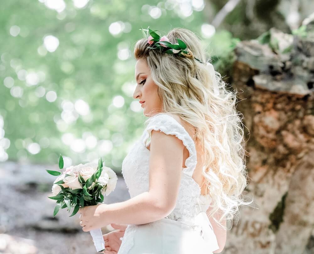 Woman walking holding wedding bouquet