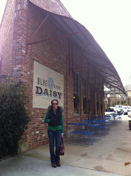 Jodi Laumer-Giddens in front of the Blue Eyed Daisy at Serenbe
