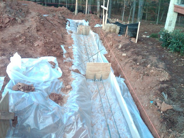 Proud Green Home Construction Update Foundation Footing 6 mill poly Capillary Break