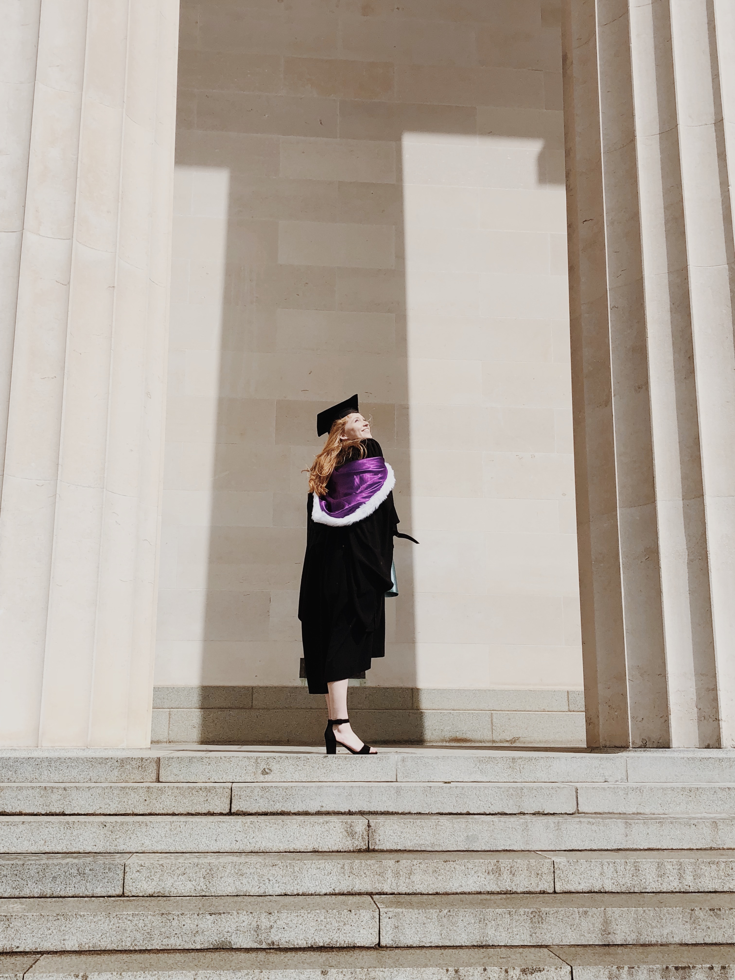 Law graduate throwing hat in the air.