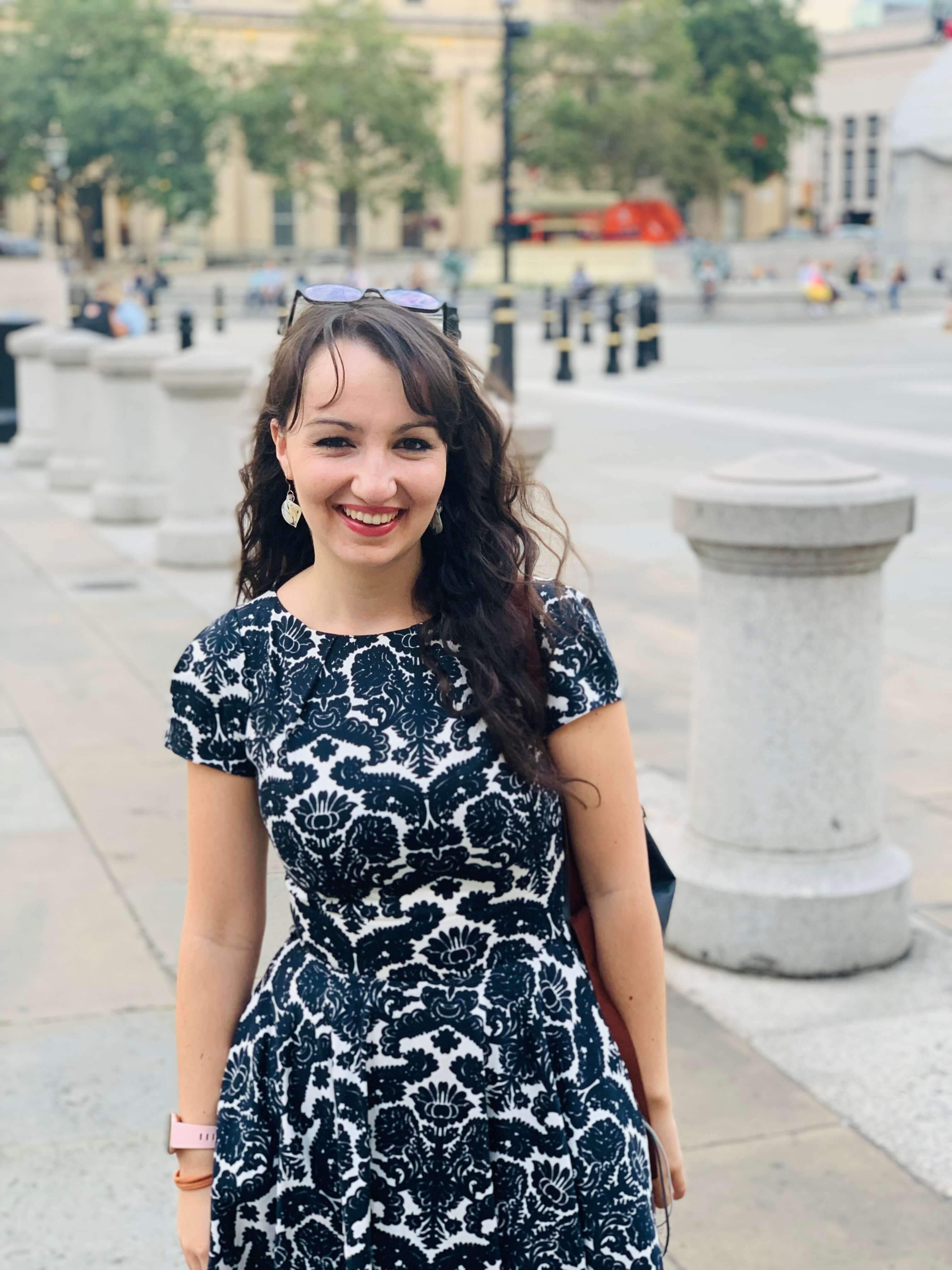 Beth wearing a smart dress in Trafalgar Square.