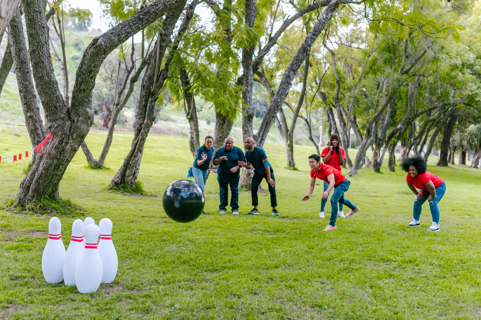 People bowling with makeshift bowling.