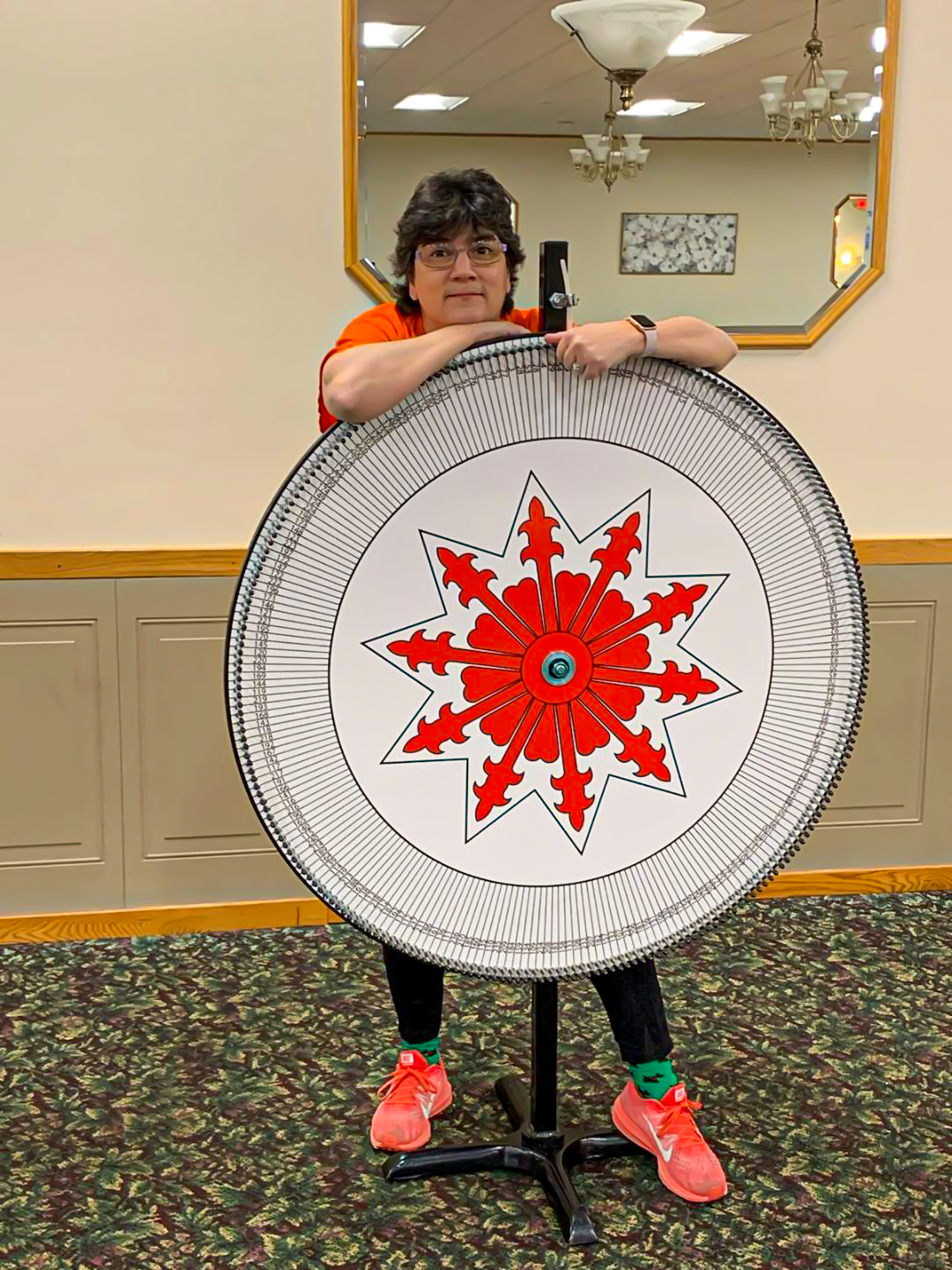 Woman standing behind meat raffle wheel