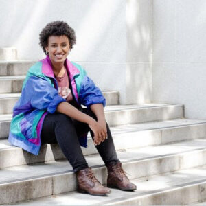 Rediet Abebe sitting on stairs outside