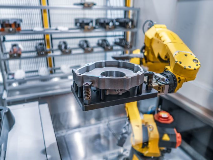 Robotic arm in clean room holding a casting metal part