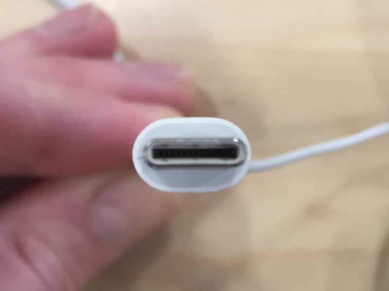 A human hand holding USB-C