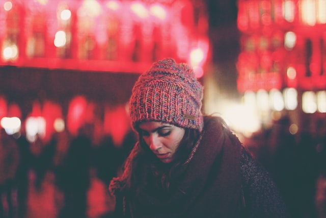 woman in winter clothing with head down thinking she can't do anything right