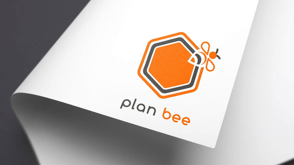 a hexagon with a bee logo