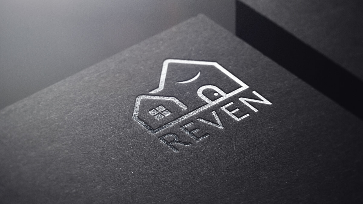 house and garage logo for Reven on a black mockup with silver plated graphic