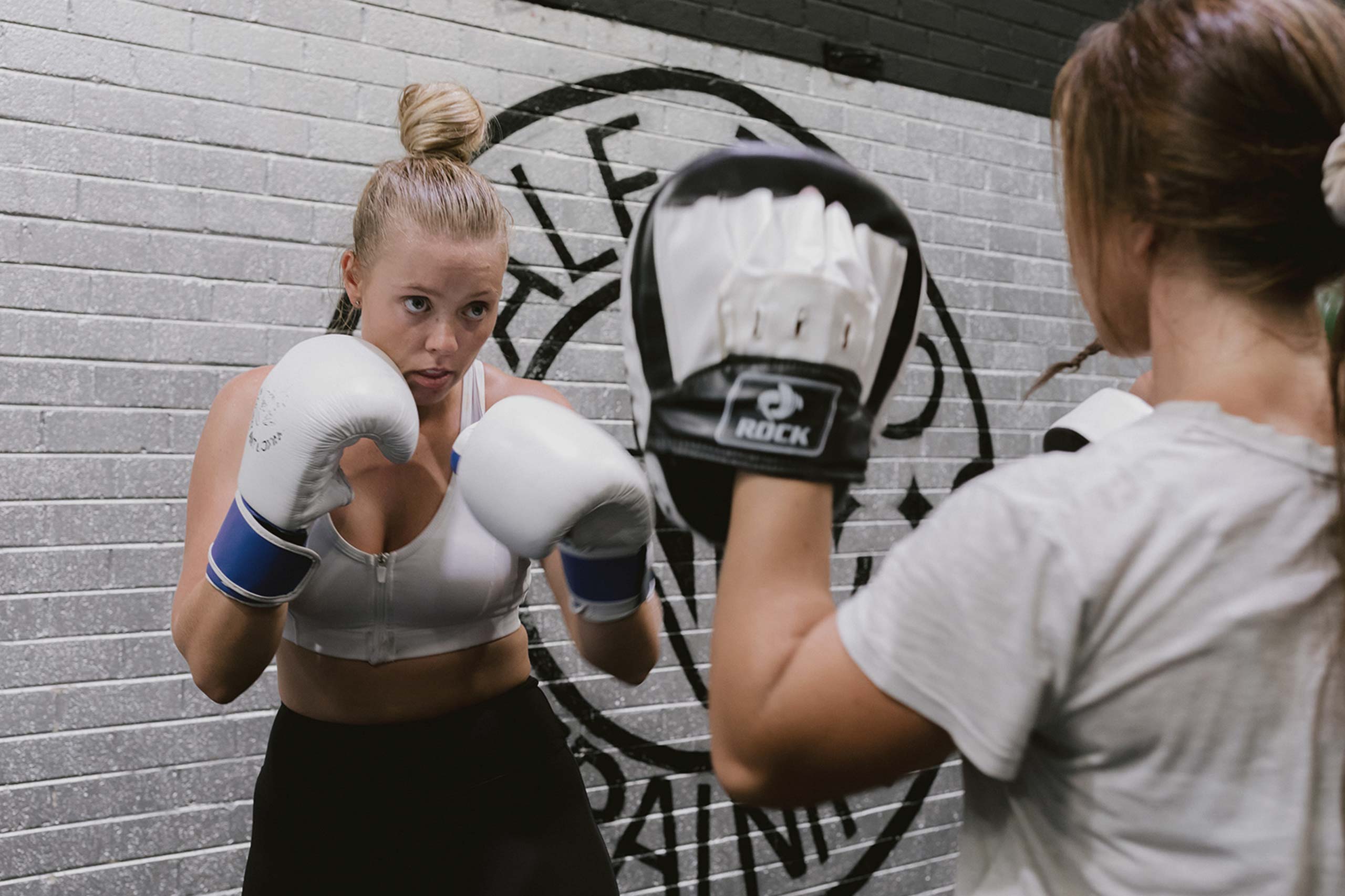 female athletes sparring in boxing training exercise