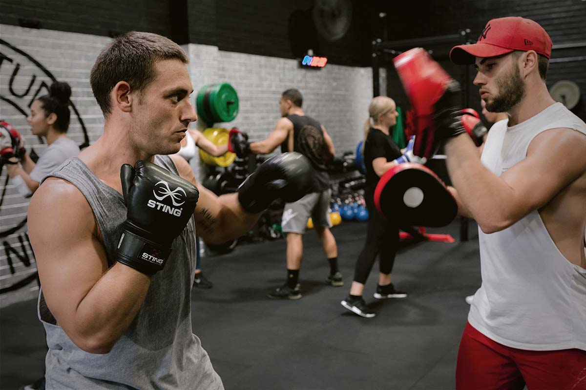 male athletes training boxing sparring