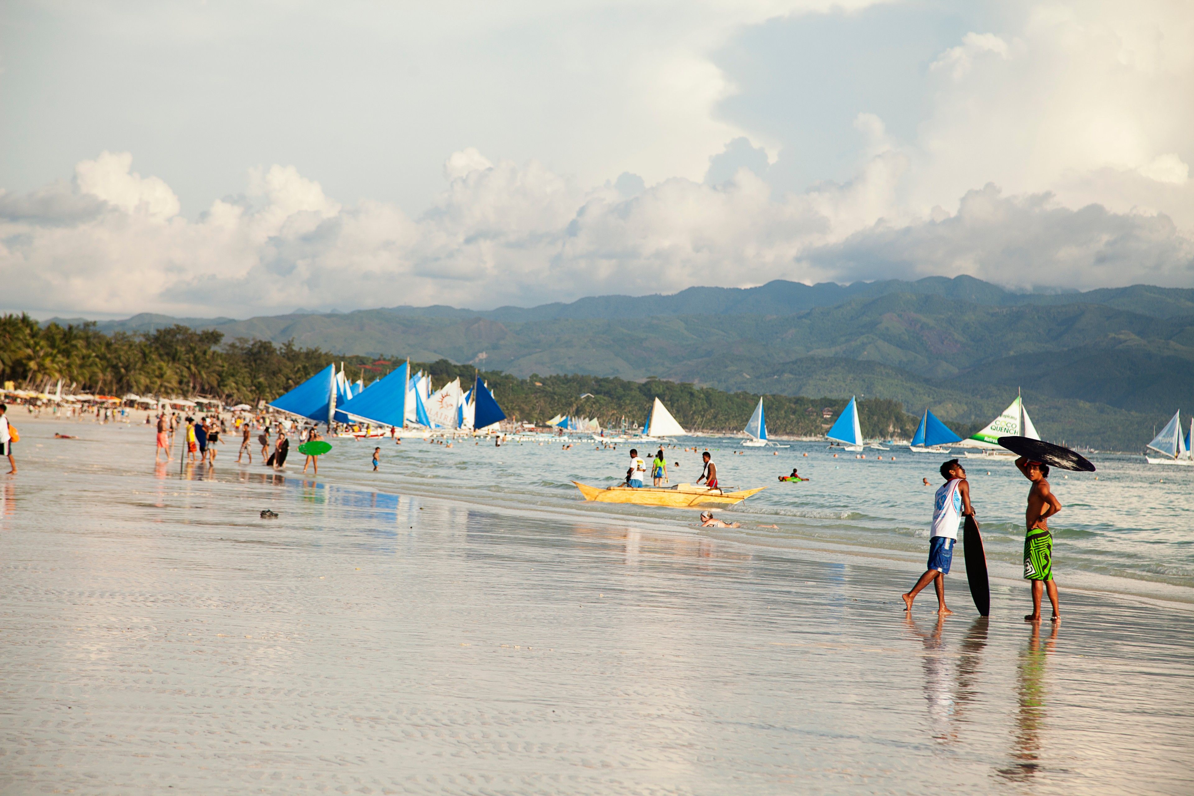 Landscape photo of tourists along Boracay's white sand beach before 2020