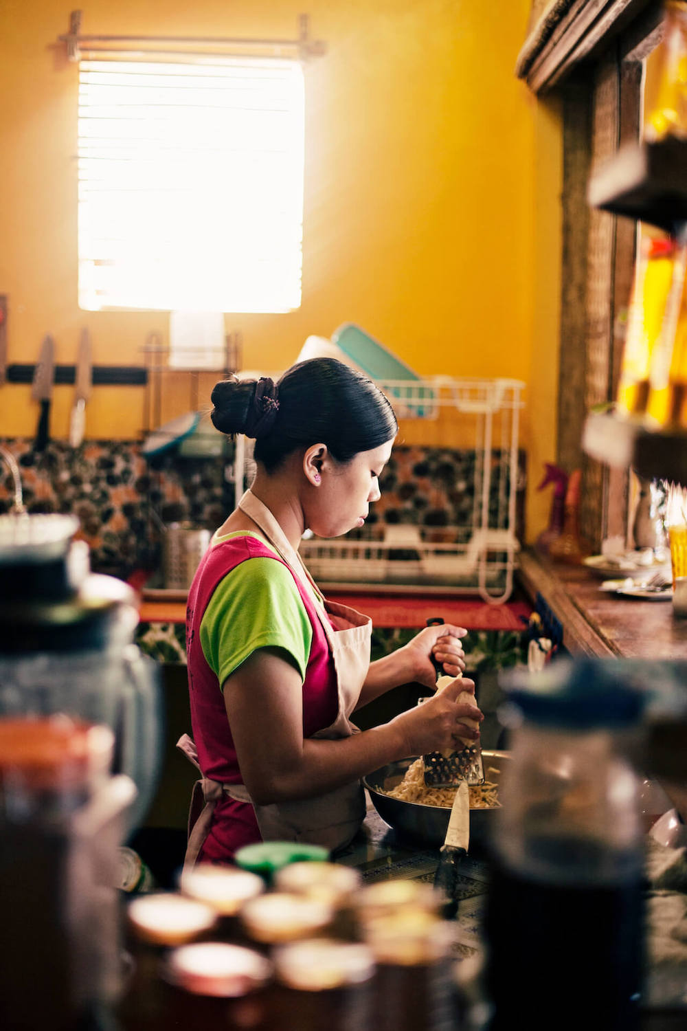 A woman prepares ingredients at Spicebird Boracay
