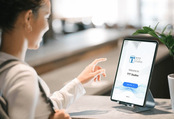 Person checking-in to office using facial recognition software on iPad