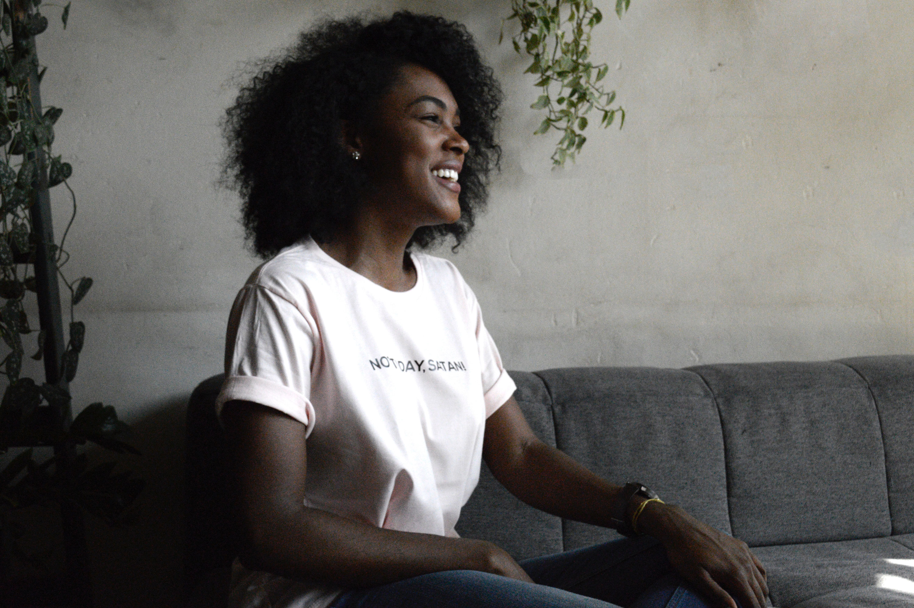 A woman smiling on a couch