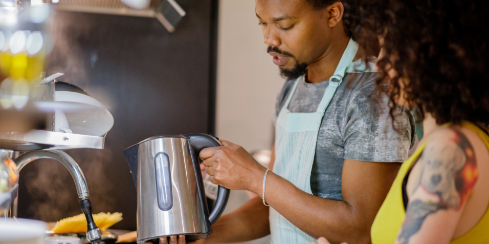 A Photo Of A Person Washing A Tea Kettle