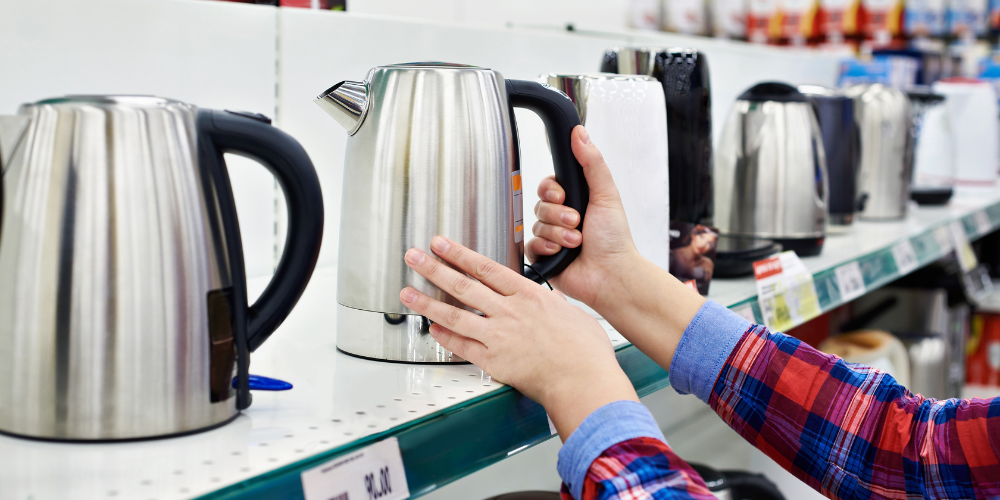 A Person Deciding Which Tea Kettle To Buy