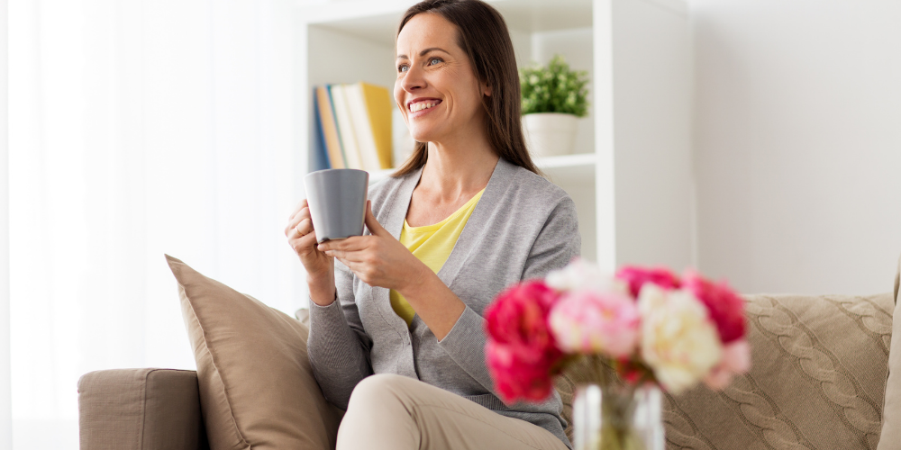 A Photo Of A Woman Holding A Mug