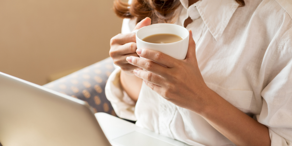 A Photo Of A Woman Holding A Cup Of Coffee