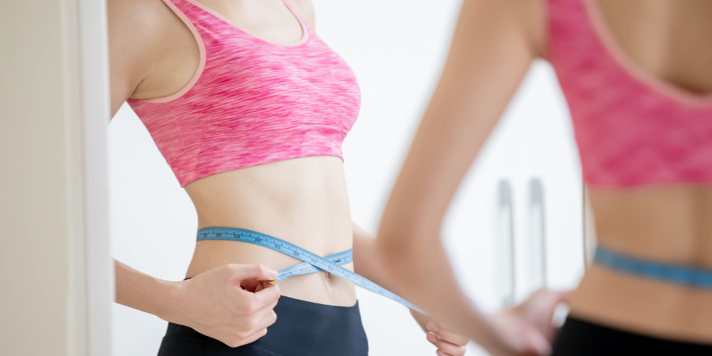 A Photo Of A Woman Measuring Her Waistline