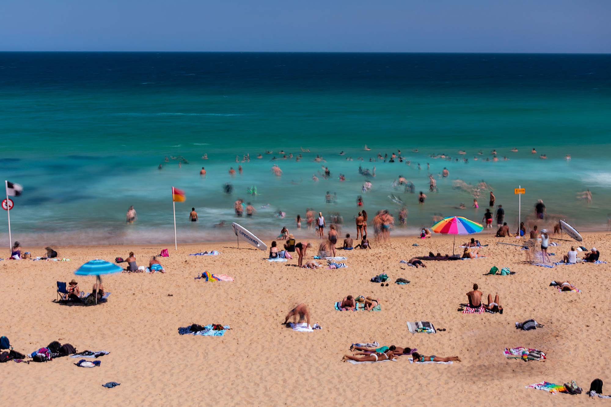 Newcastle beach with tourists on the beach in the summer.
