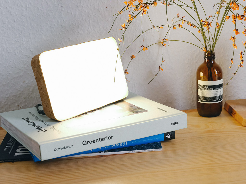 A SAD light therapy lamp on top of a stack of books