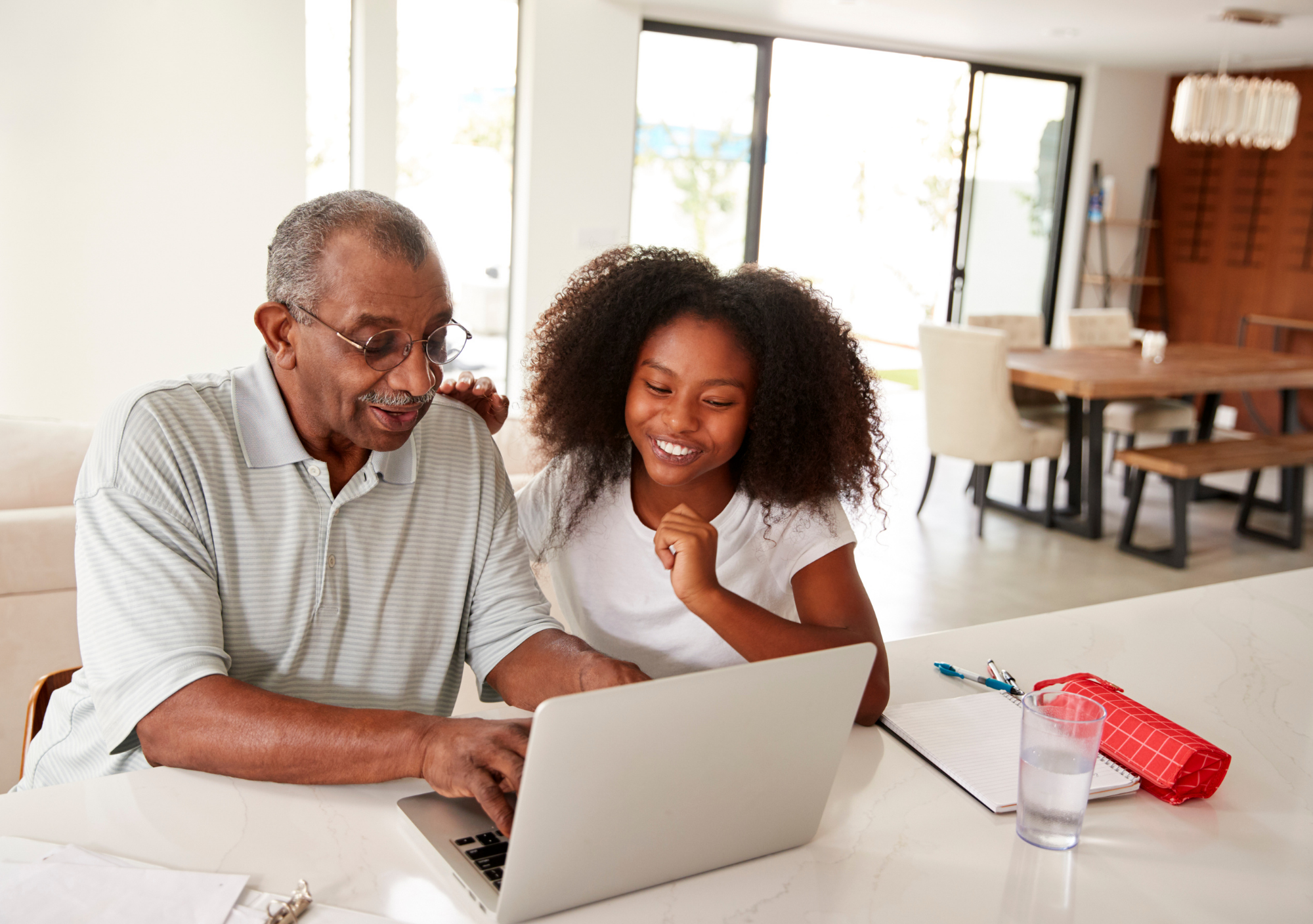 Granddaughter helps Grandfather on a laptop computer