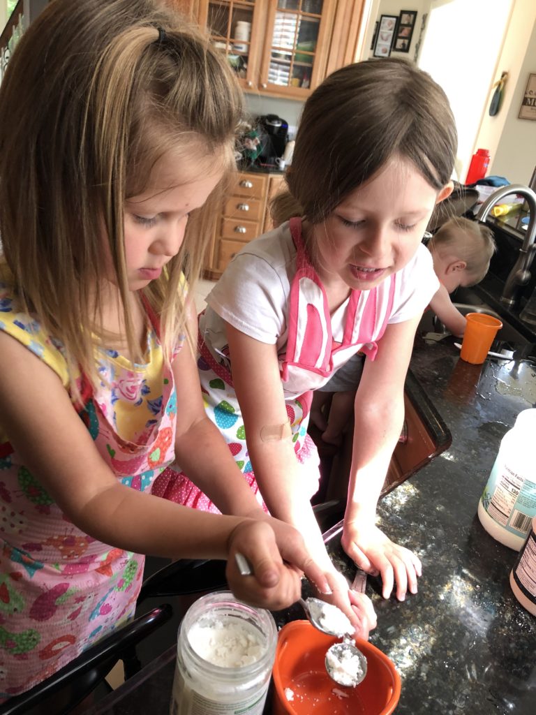 The girls creating summer memories by making donuts