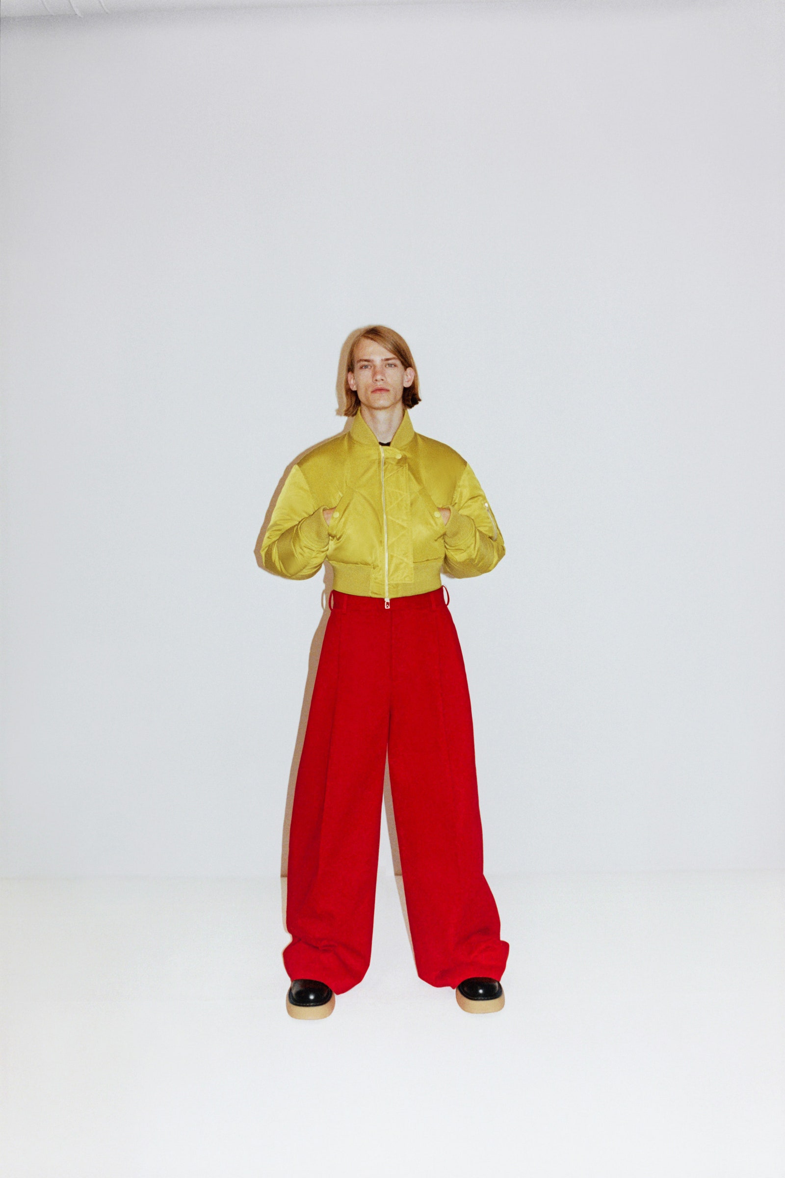 Image may contain Clothing Apparel Pants Human Person Coat Female Architecture and Building