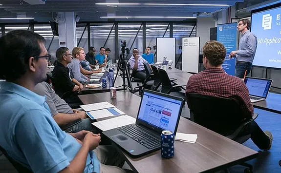 adult students in a modern classroom during a cybersecurity training class