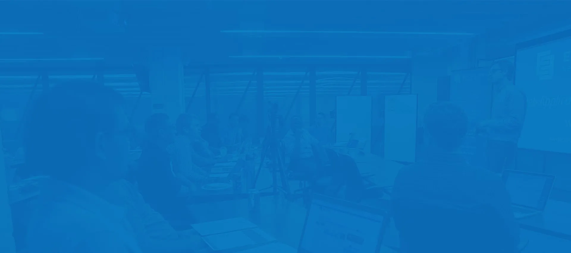 adult students in a modern classroom during a cybersecurity training class