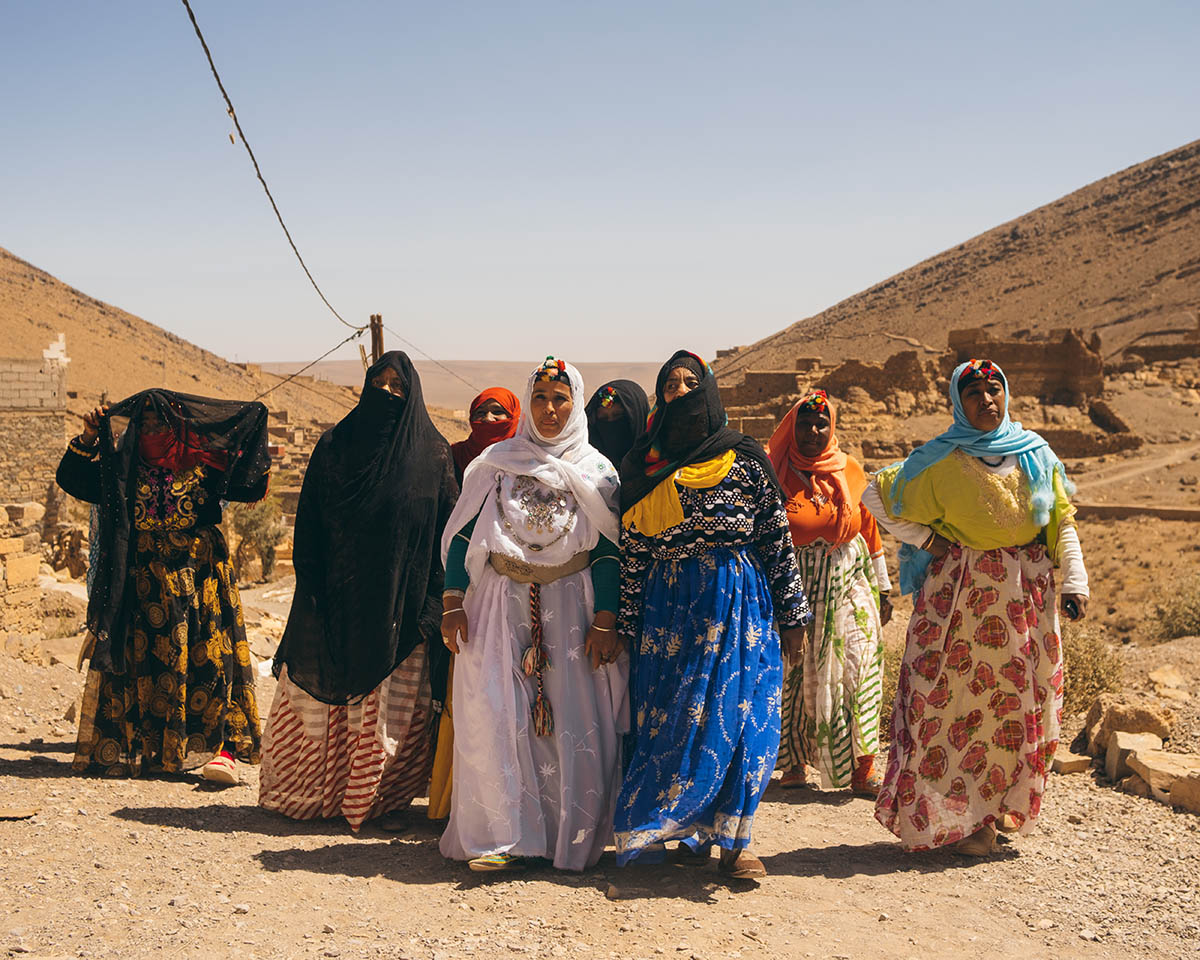A group of women weavers walk in the Anti Atlas mountains.